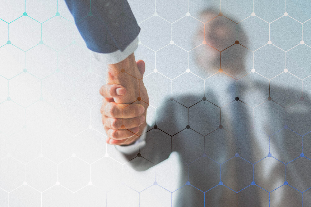 Business handshake with hexagonal overlay